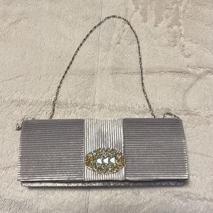Silver evening purse with silver/gold bling on pocketbook.  Great condition!